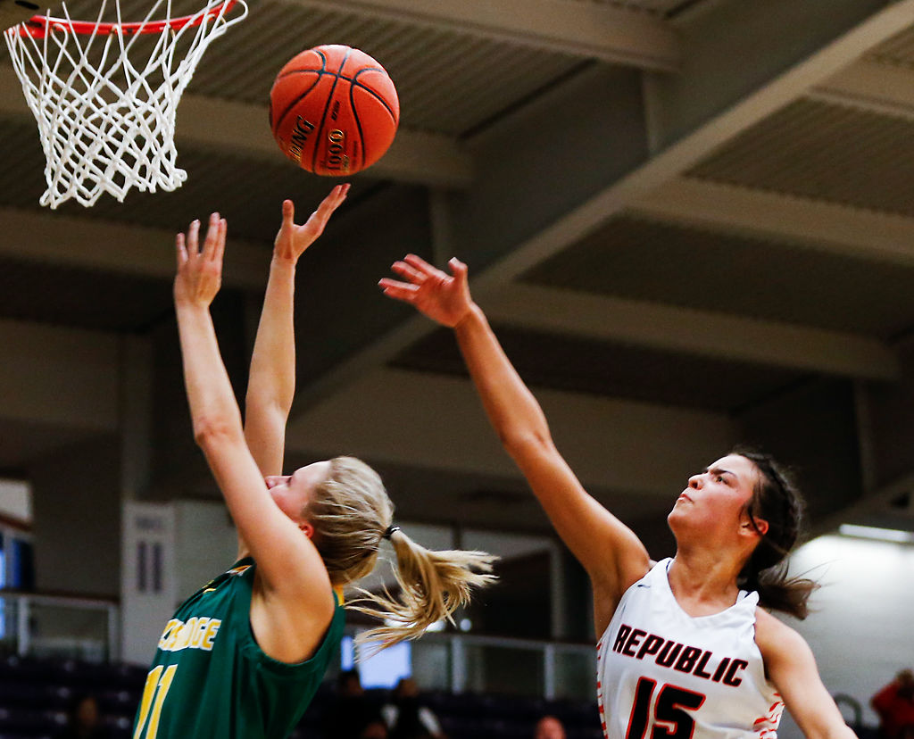 Republic high school guard Jazzy Kirby attempts to block a shot by Rock Bridge high school guard Mary Primus